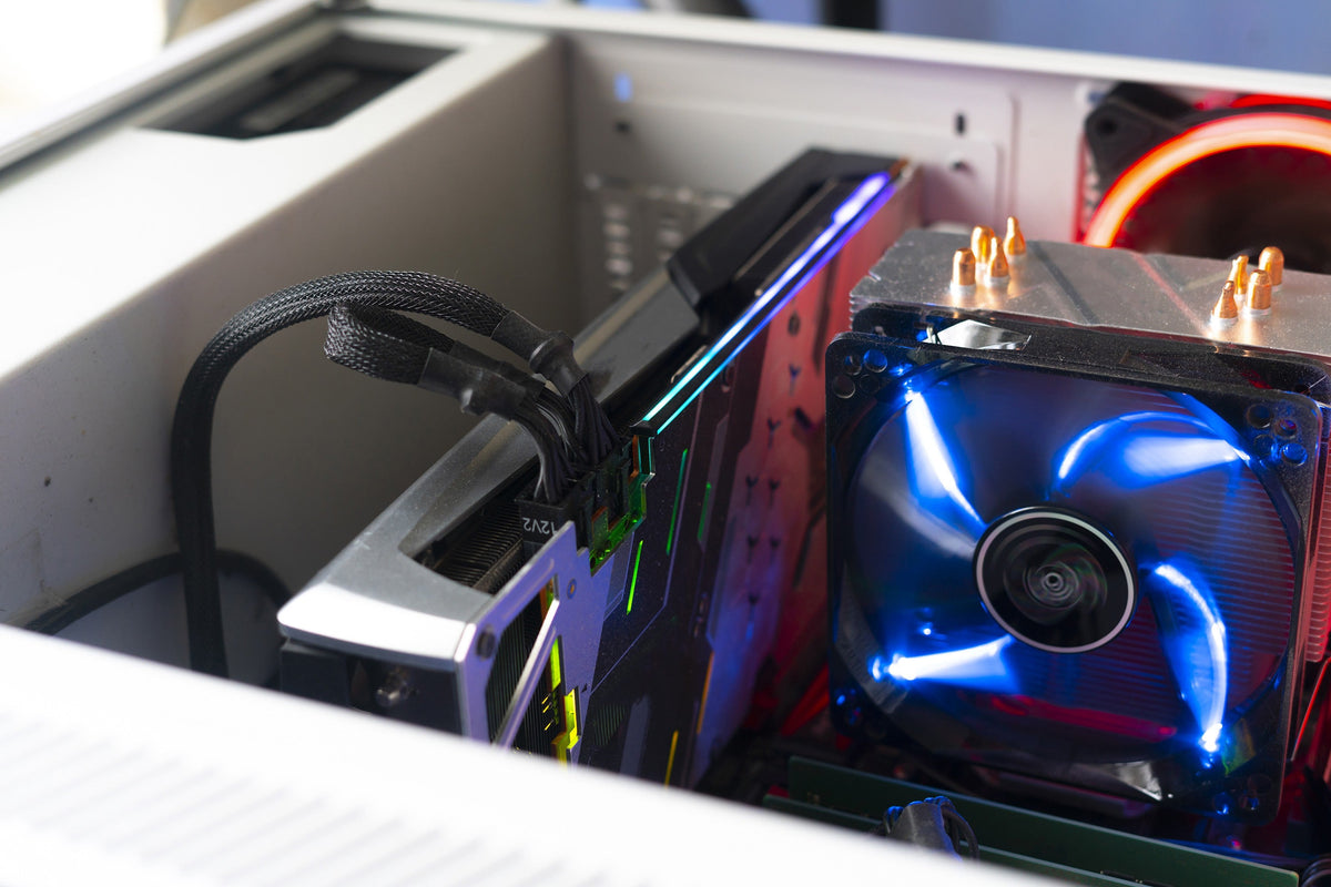 Graphics card installed in a computer alongside cooling fans