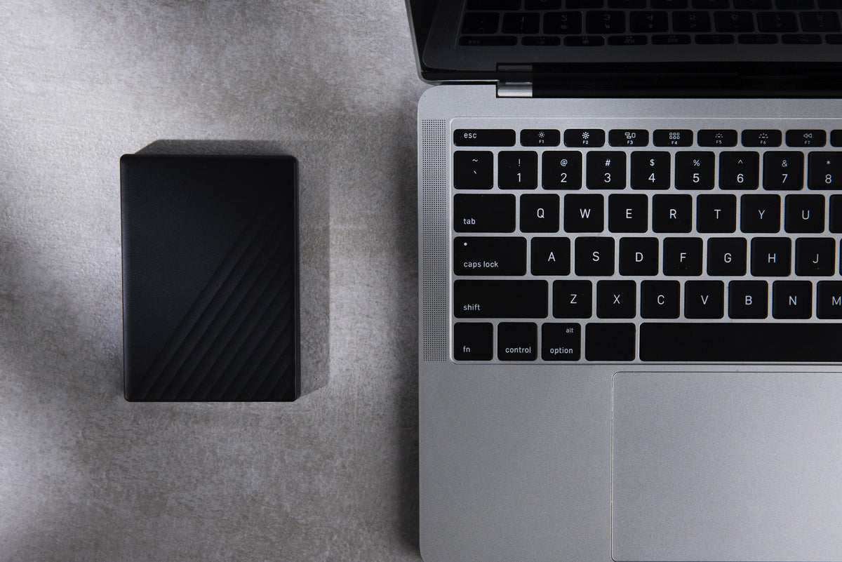External hard drive and laptop laid out for an IT equipment valuation