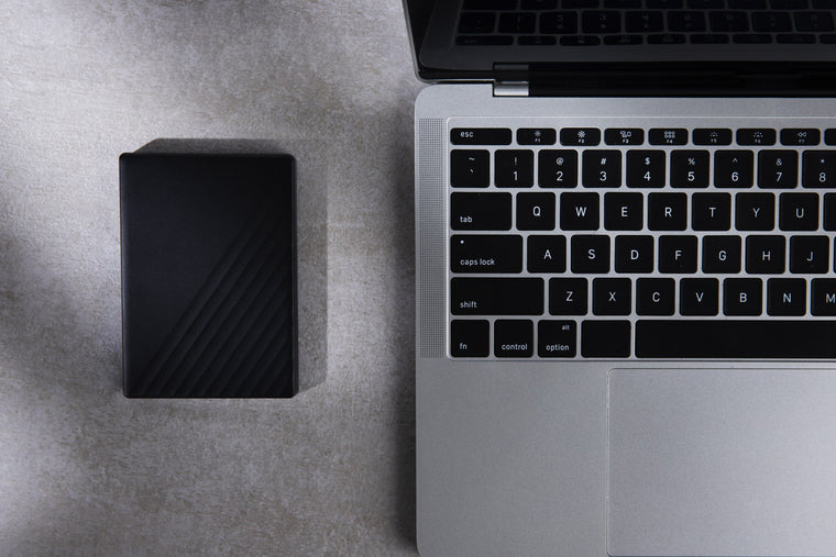External hard drive and laptop laid out for an IT equipment valuation